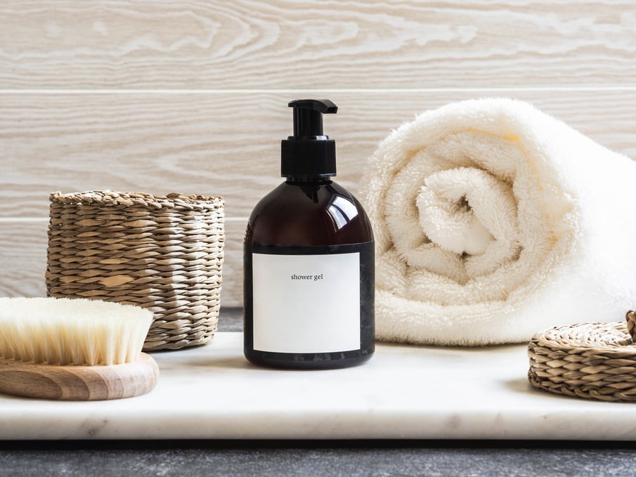 Shower Gel and Towel on Marble Table 